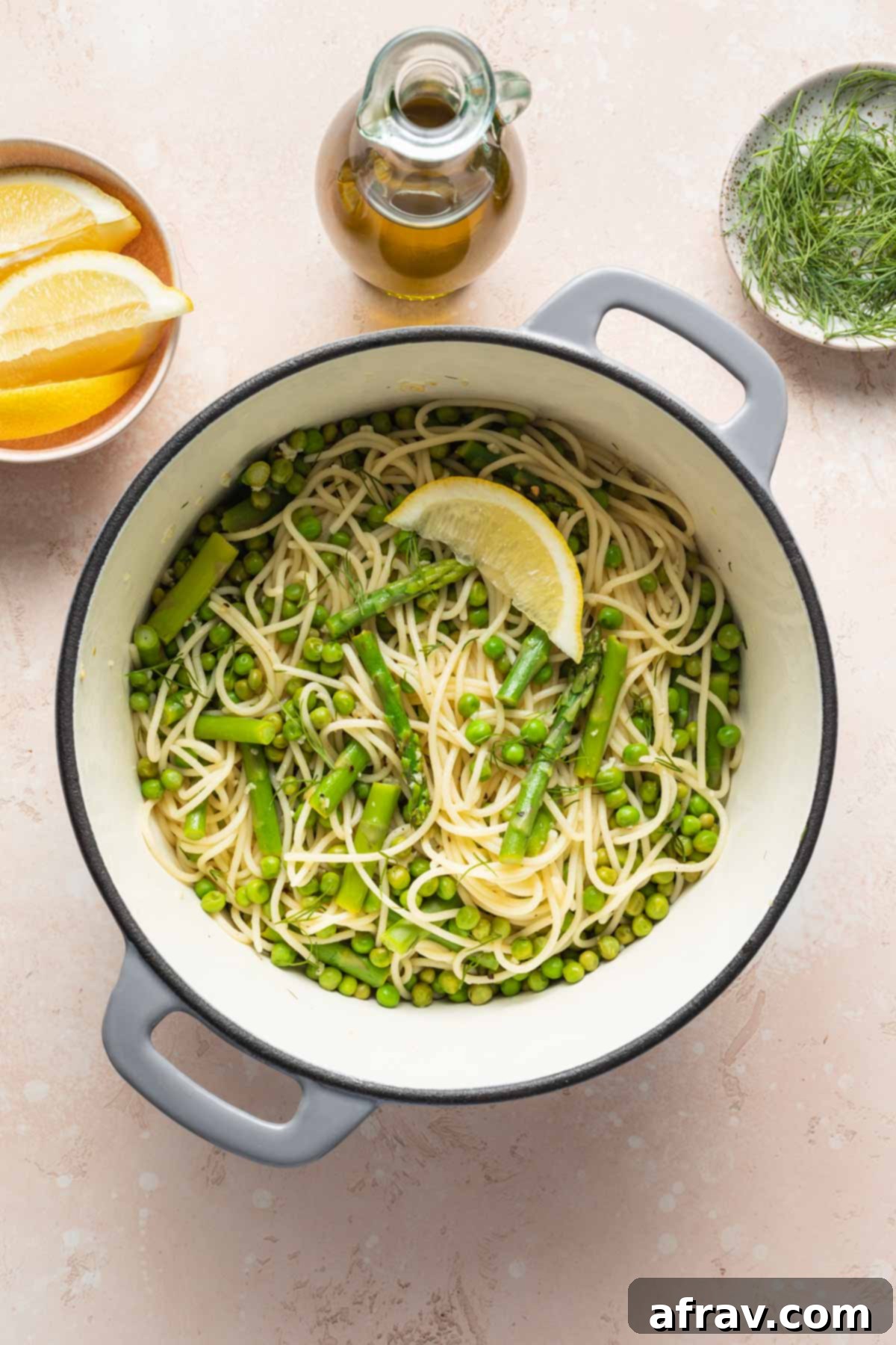 Lemon garlic pasta with peas and asparagus in a pot.