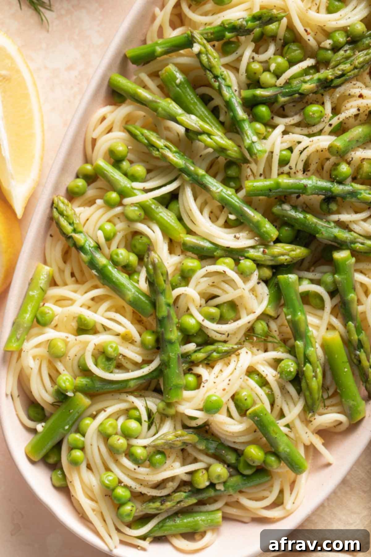 Close up view of pasta with asparagus and peas.