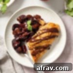 Rustic Almond Cherry Galette 8 A slice of cherry galette topped with melted chocolate and served on a white plate.