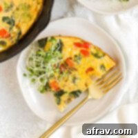 Piece of vegetable frittata on a small white plate.