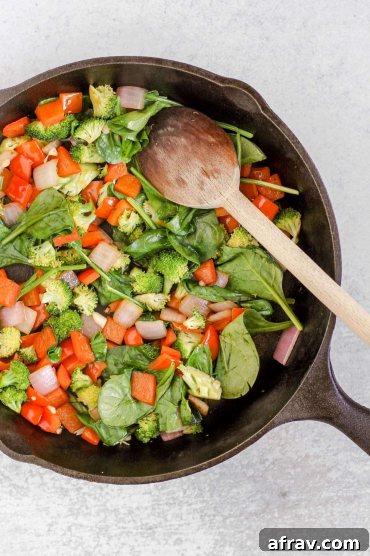 Sautéed vegetables in a cast iron skillet.