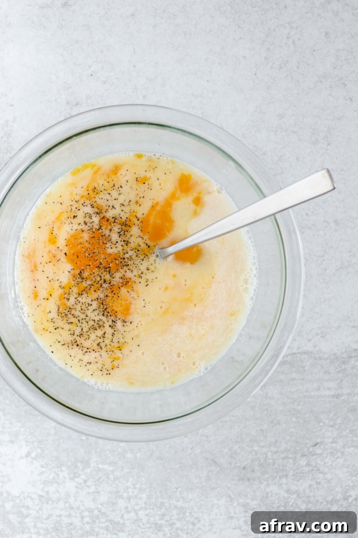 Eggs whisked with dairy-free milk in a bowl.