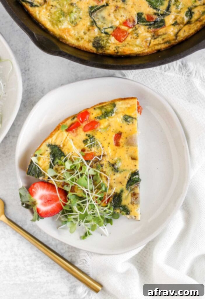 A piece of vegetable frittata on a small white plate.