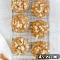 Apple cinnamon oat muffins on a wire cooling rack.