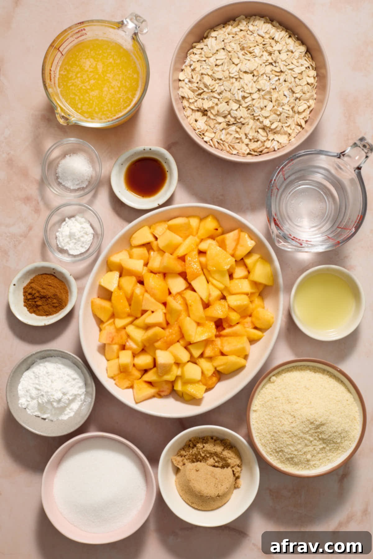 Ingredients to make almond flour peach bars arranged in separate bowls and measuring cups, ready for preparation.