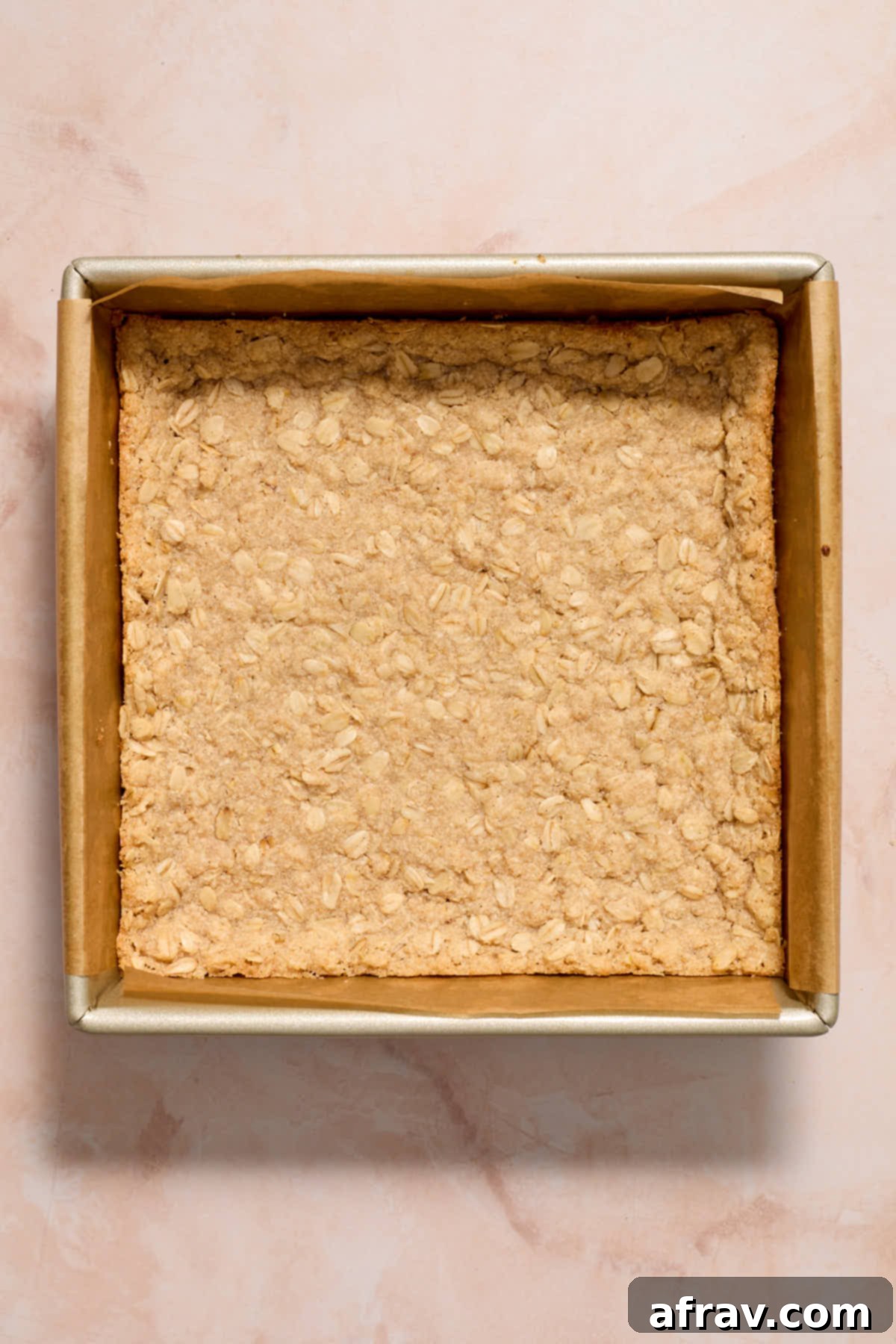 Crust baked in the square pan, showing slightly golden edges.