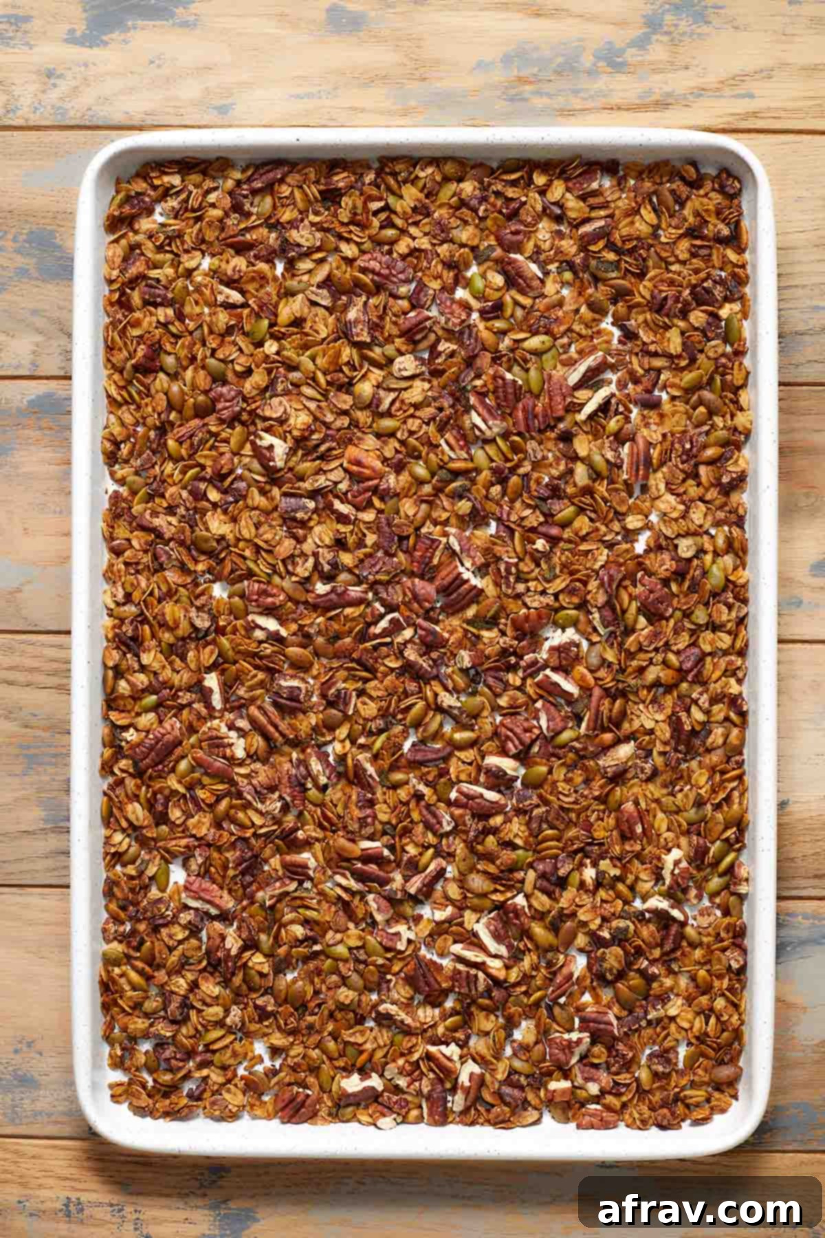 Robust Pecan Crunch Granola 6 Baked granola cooling on a baking sheet, showing its golden brown color.