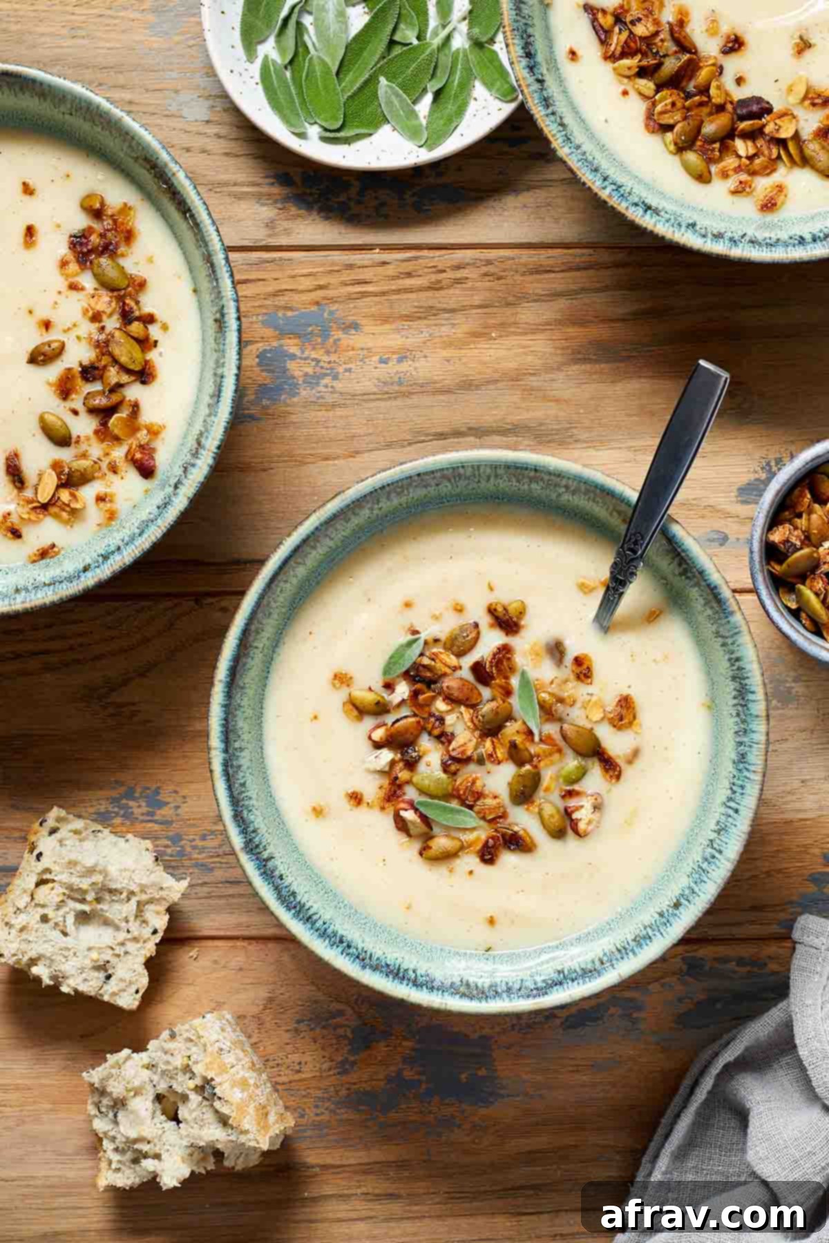 Robust Pecan Crunch Granola 7 Savory granola on tops of bowls of parsnip soup, illustrating its use as a topping.