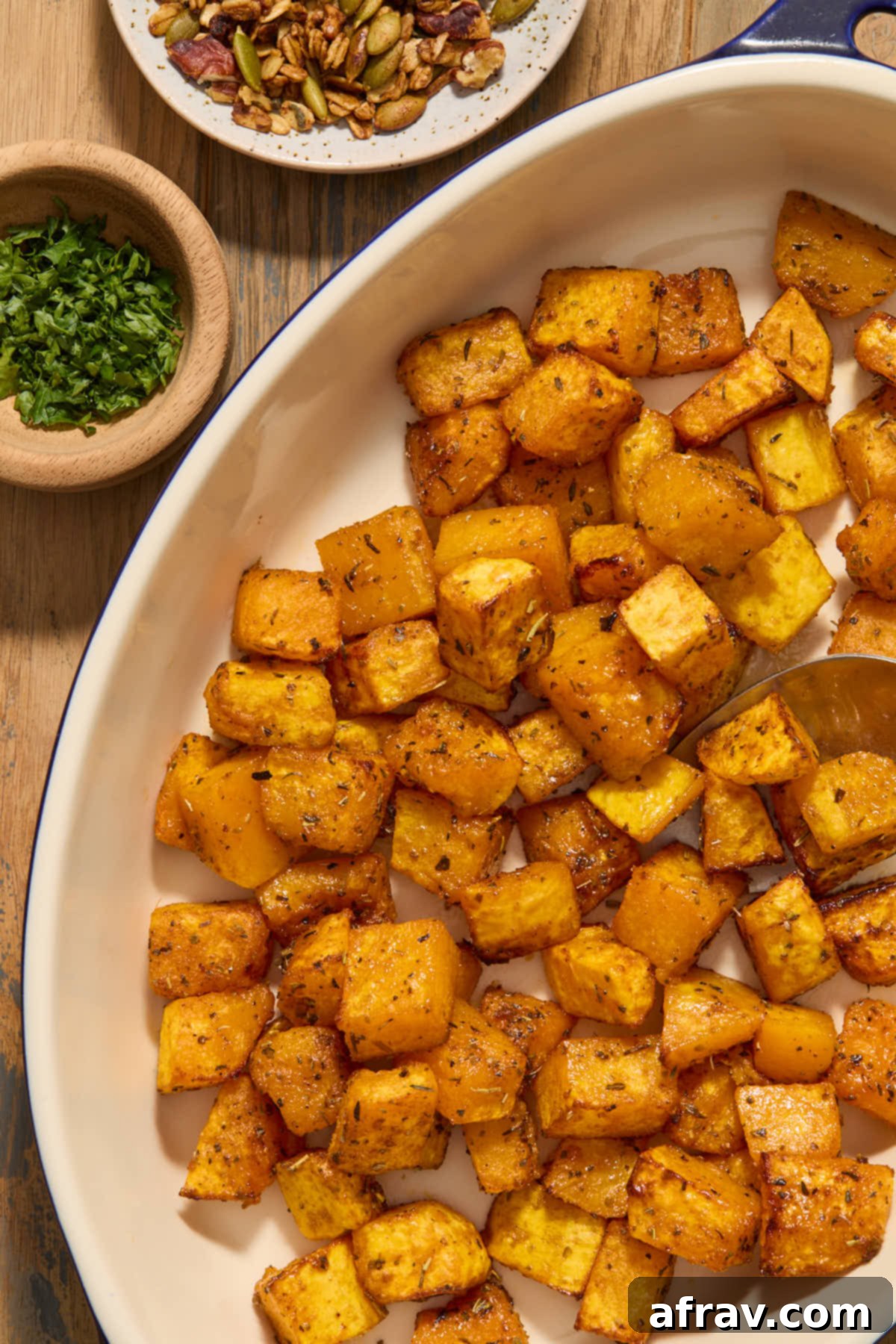 Close-up of air fried butternut squash cubes, seasoned and golden, beautifully arranged in a serving dish, ready to be enjoyed.