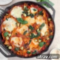 Overhead view of vegetarian lasagna in a cast iron skillet.