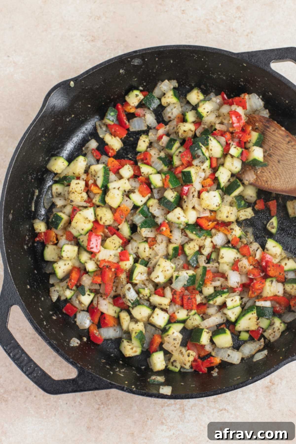 Sauteed veggies in cast iron skillet, ready for sauce.
