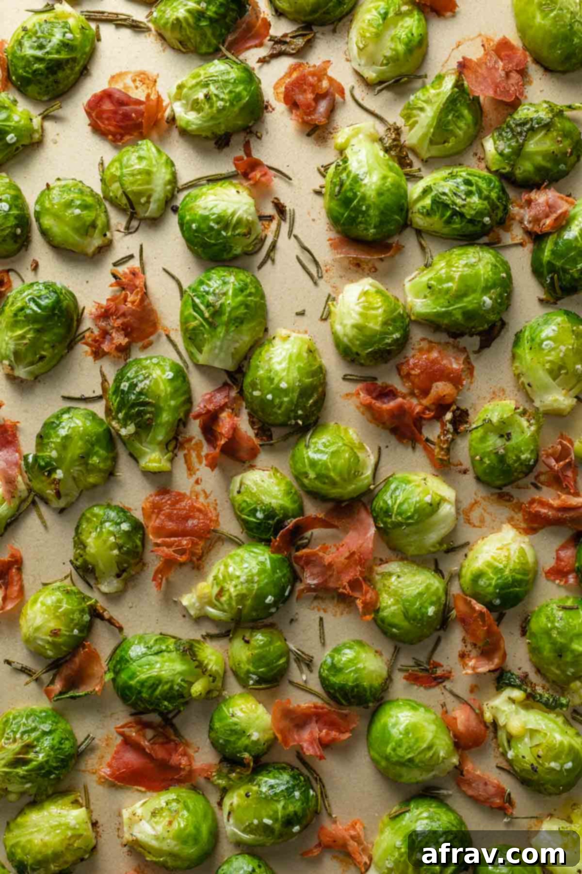 Close up of prosciutto and Brussels sprouts on a sheet pan, showing the crispy texture.