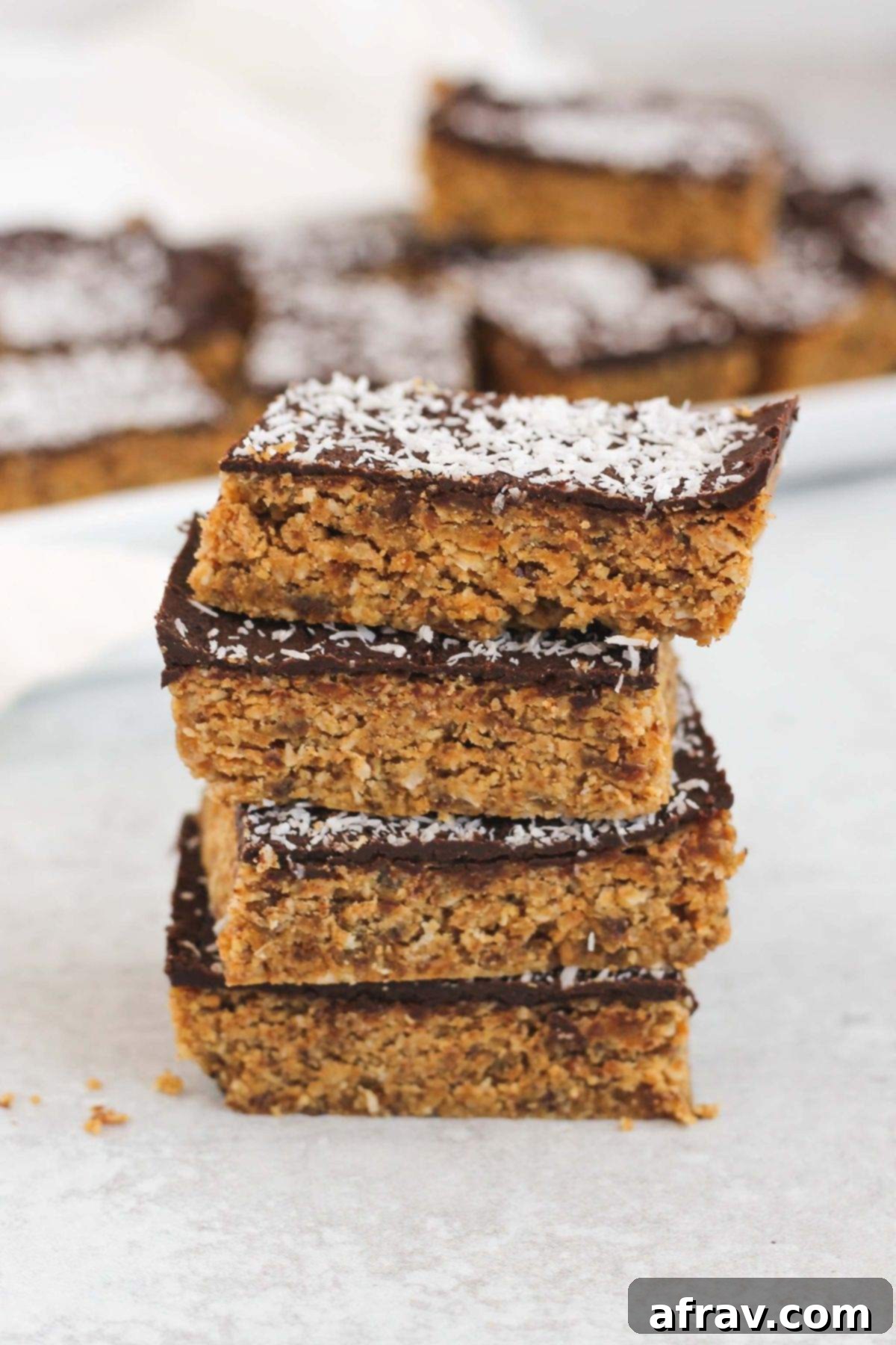 Delicious No-Bake Peanut Butter Oatmeal Bars 2 Peanut butter oat bar squares stacked 4 high.