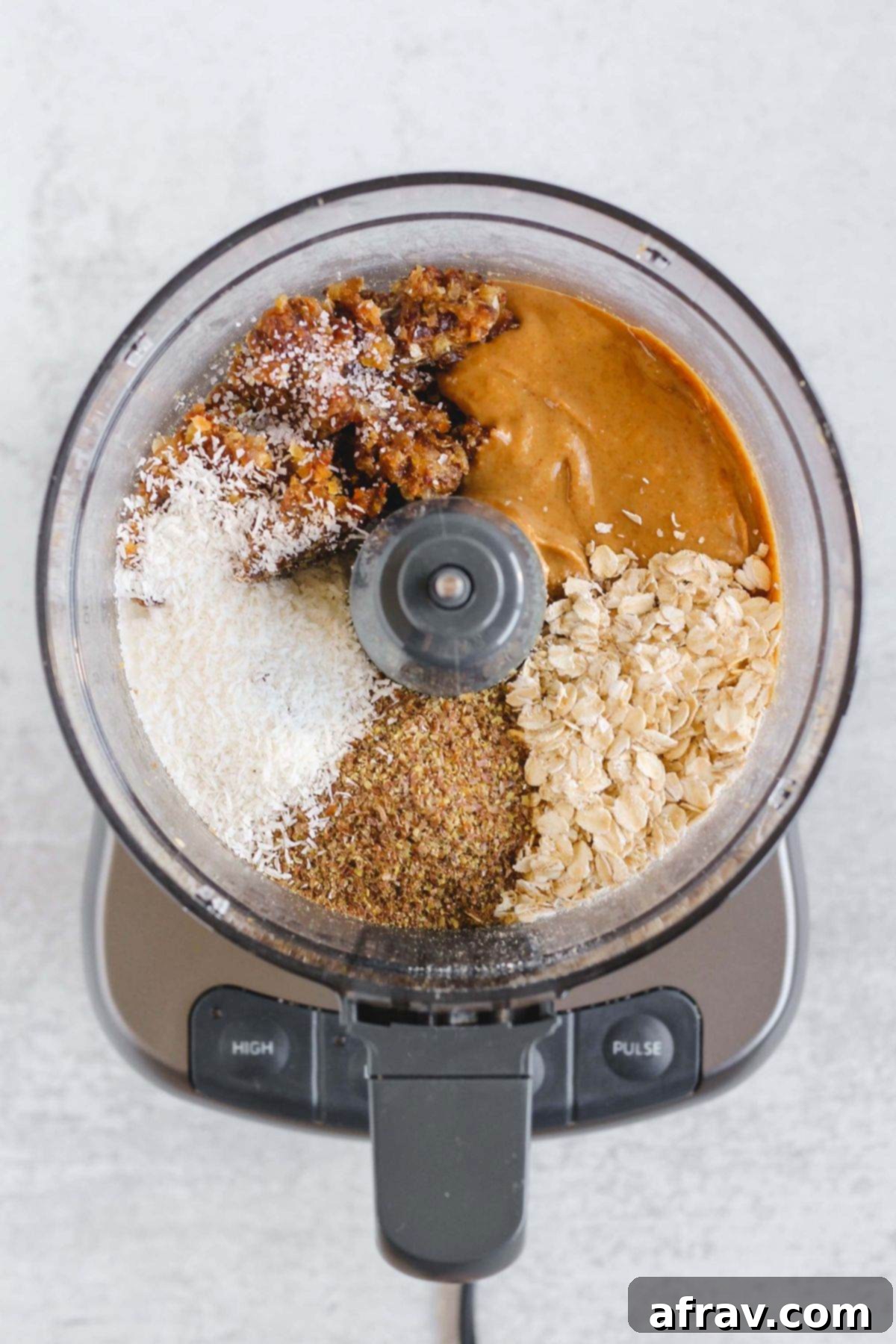 Delicious No-Bake Peanut Butter Oatmeal Bars 5 Dates, peanut butter, oats, flaxseeds, and shredded coconut in a food processor.