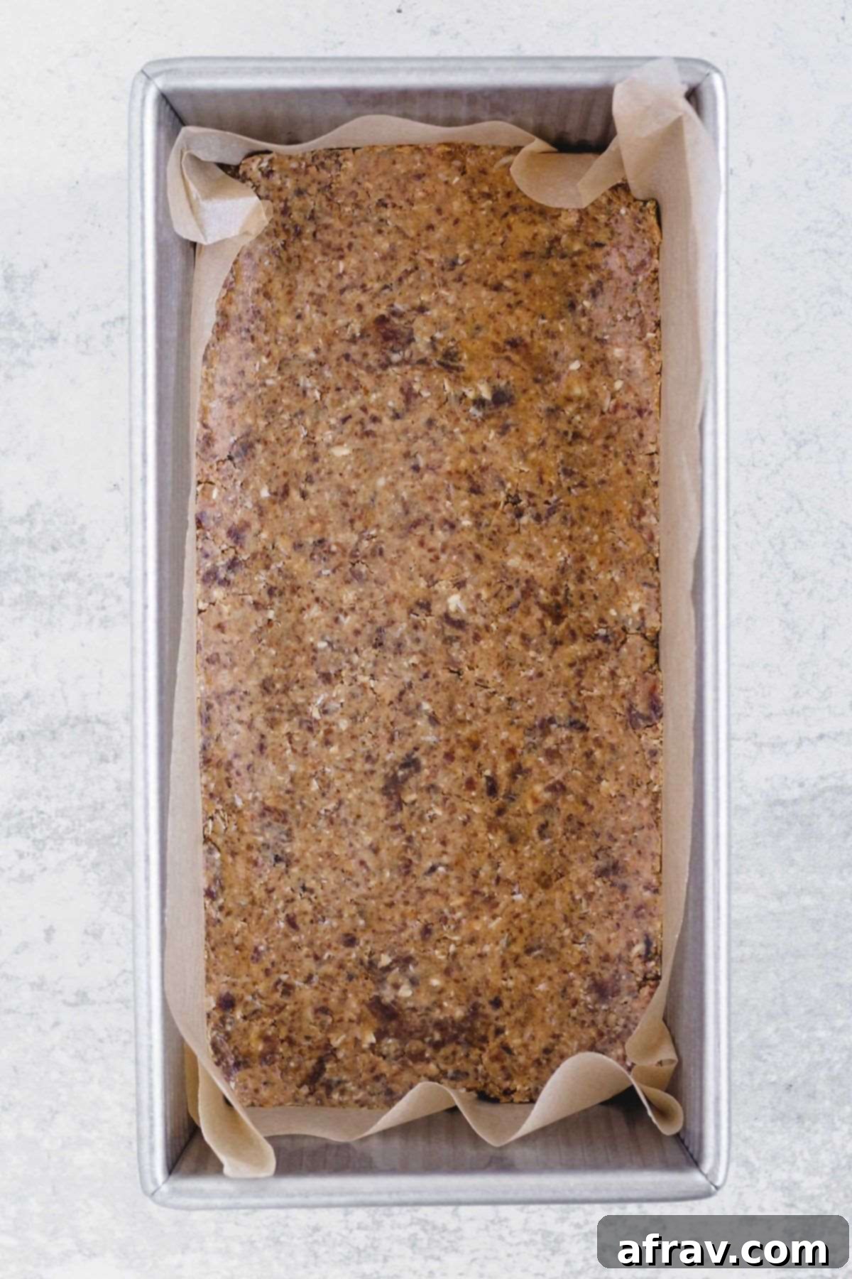 Delicious No-Bake Peanut Butter Oatmeal Bars 7 Peanut butter oat bars pressed into the bottom of a loaf pan.