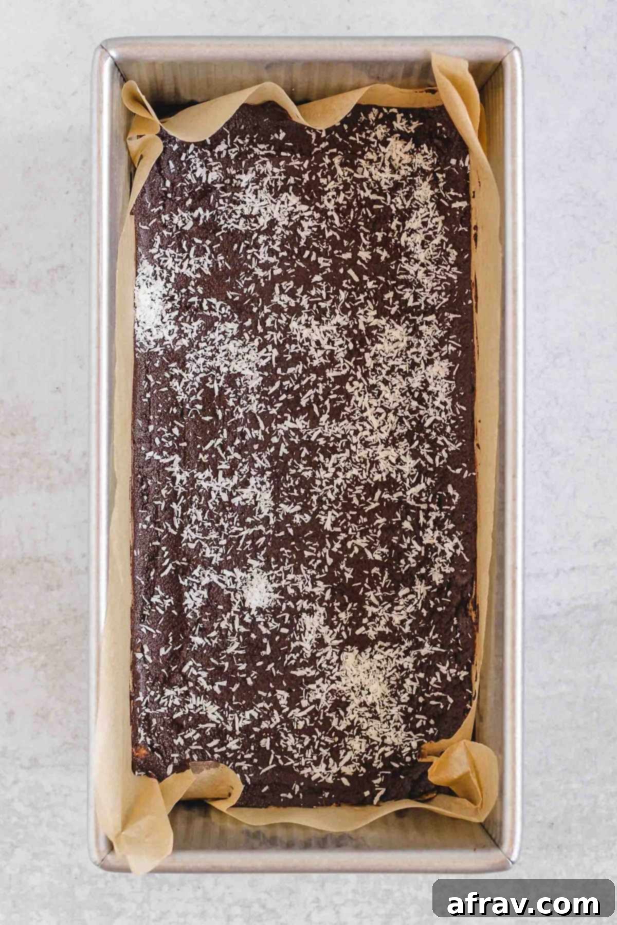 Delicious No-Bake Peanut Butter Oatmeal Bars 8 Bars with chocolate topping and shredded coconut in a loaf pan.