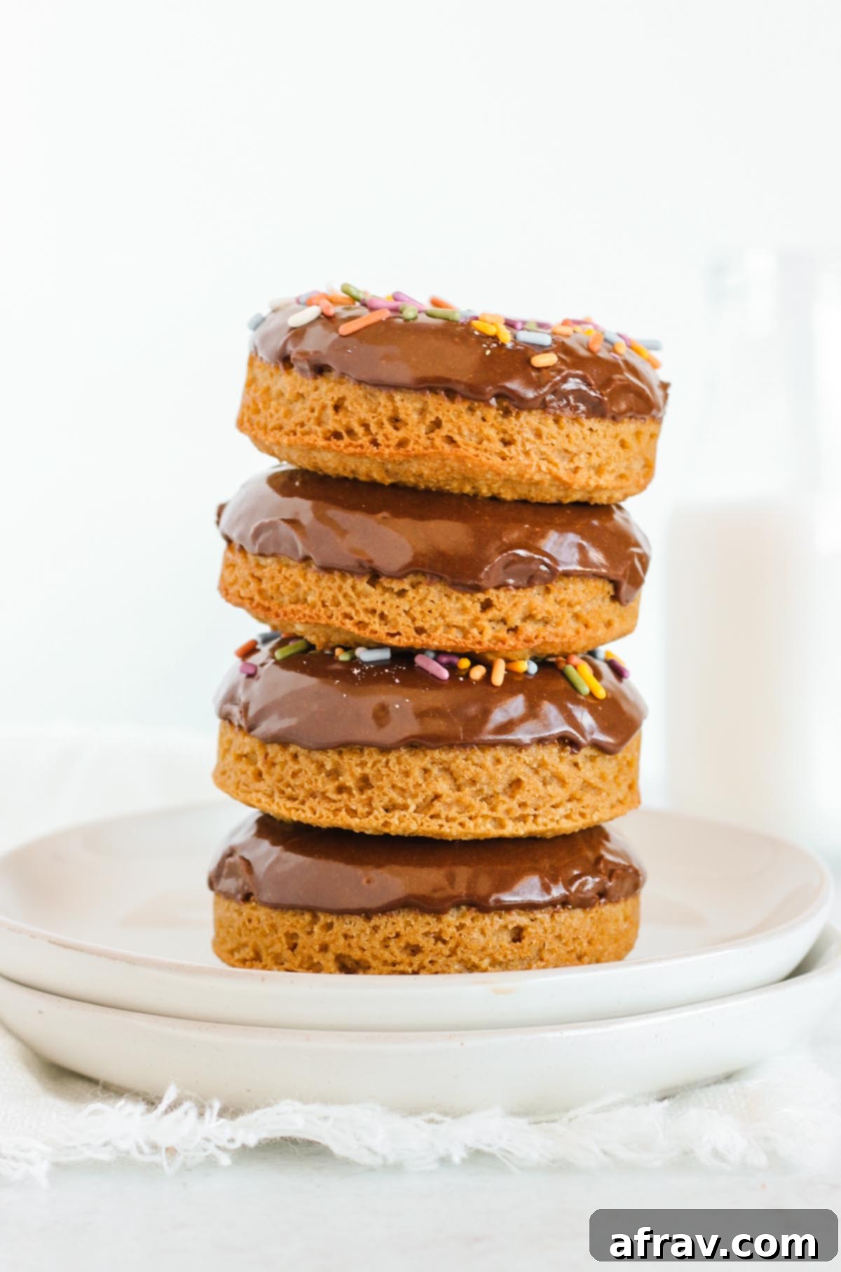 Donuts with chocolate frosting stacked 4 high.