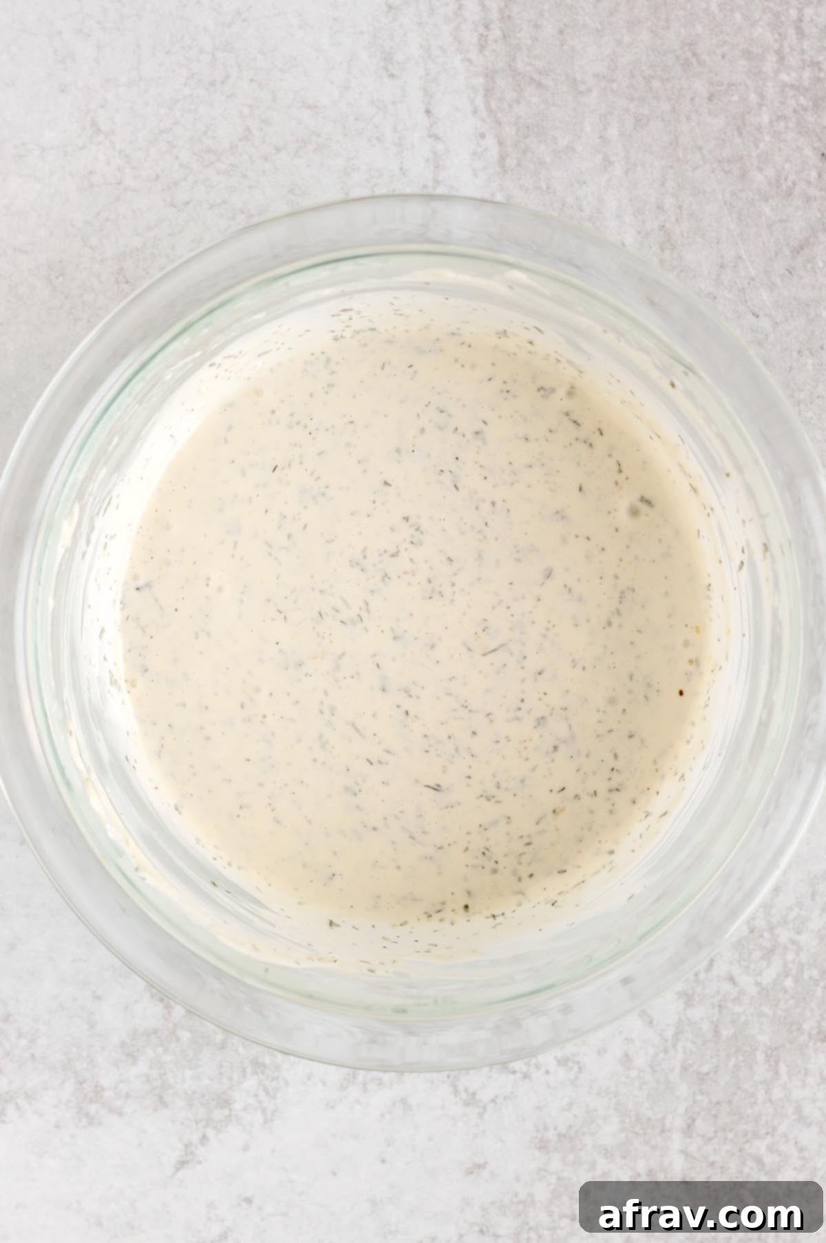 Effortless Dairy-Free Paleo Ranch Dressing 5 Dairy-free ranch dressing in a glass mixing bowl, perfectly smooth and creamy.