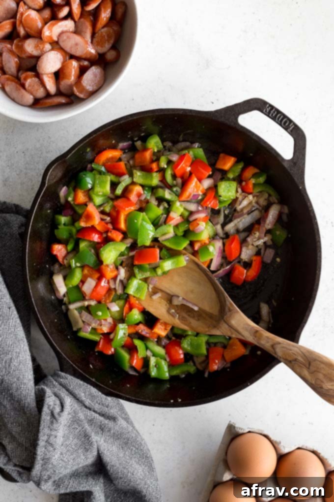 Peppers and onions sauteed in a cast iron skillet.