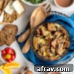 Instant Pot Egg Strata with Ham and Brie in a glass dish and cooling on a wire rack.