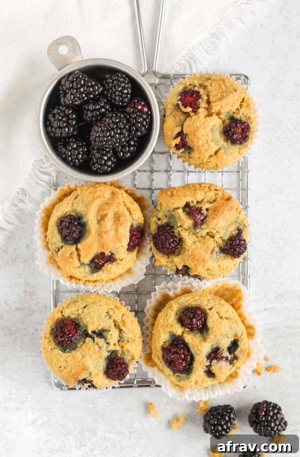 Overhead view of blackberry almond flour muffins in a wire cooling rack.