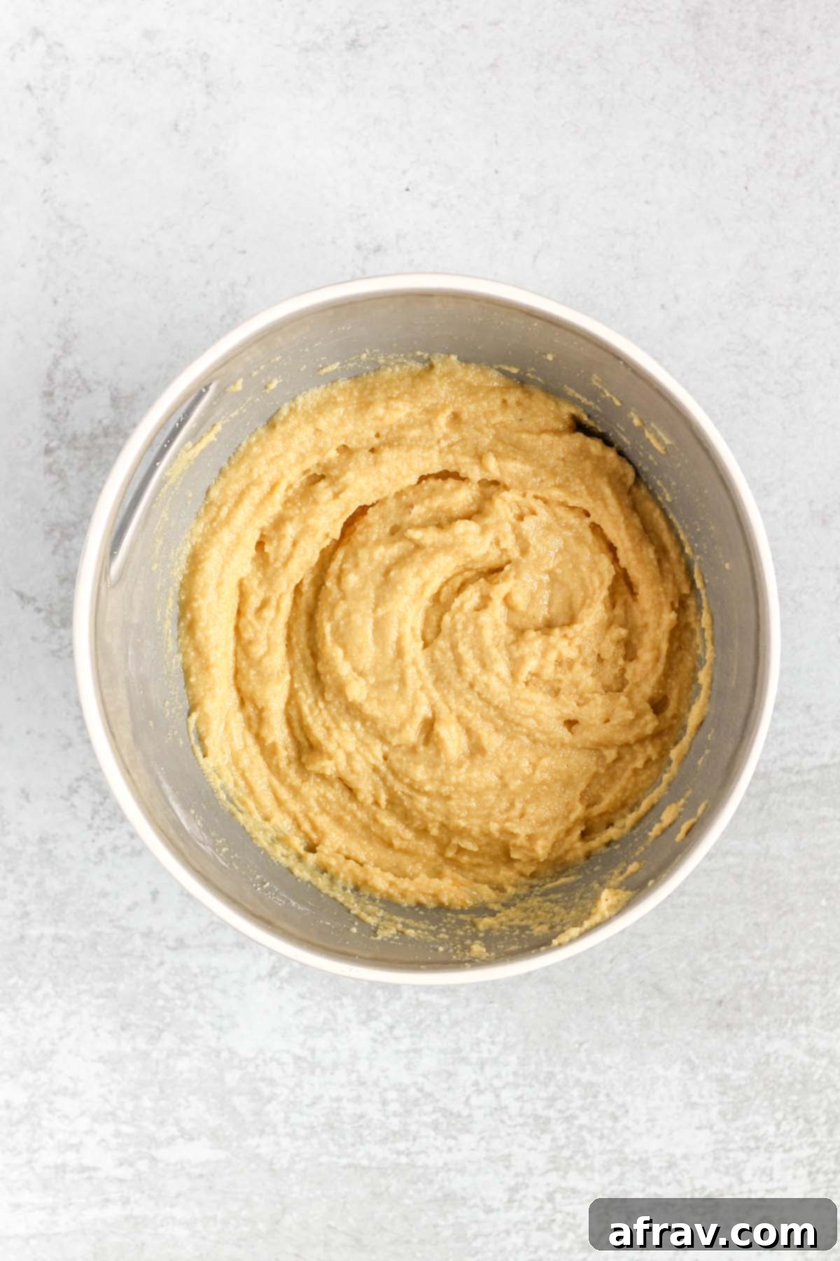 Almond flour muffin batter in a gray mixing bowl.