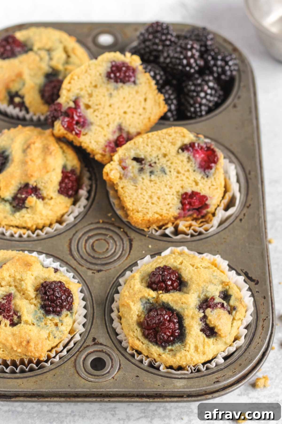 Blackberry almond flour muffins in a vintage muffin tin.