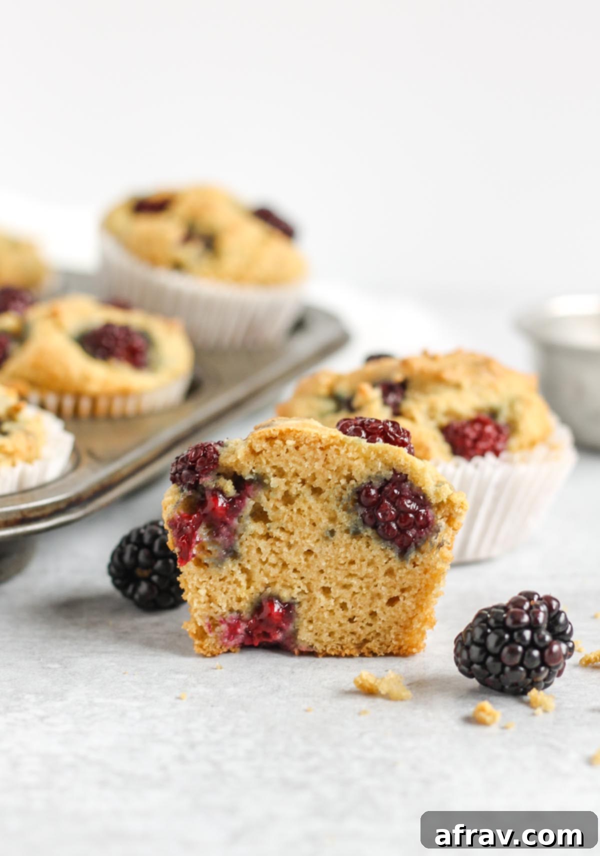Blackberry muffin that has been cut in half.