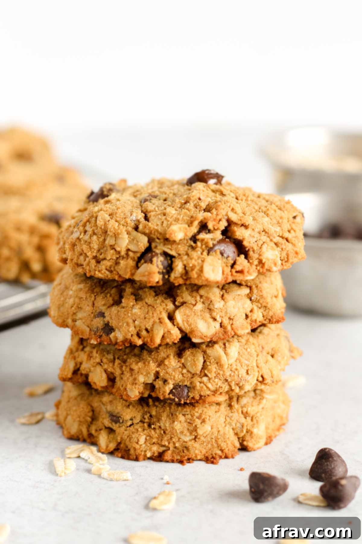 Effortless Coconut Flour Oatmeal Delights 2 Oatmeal coconut flour cookies stacked 4 high, showcasing their soft, chewy texture.