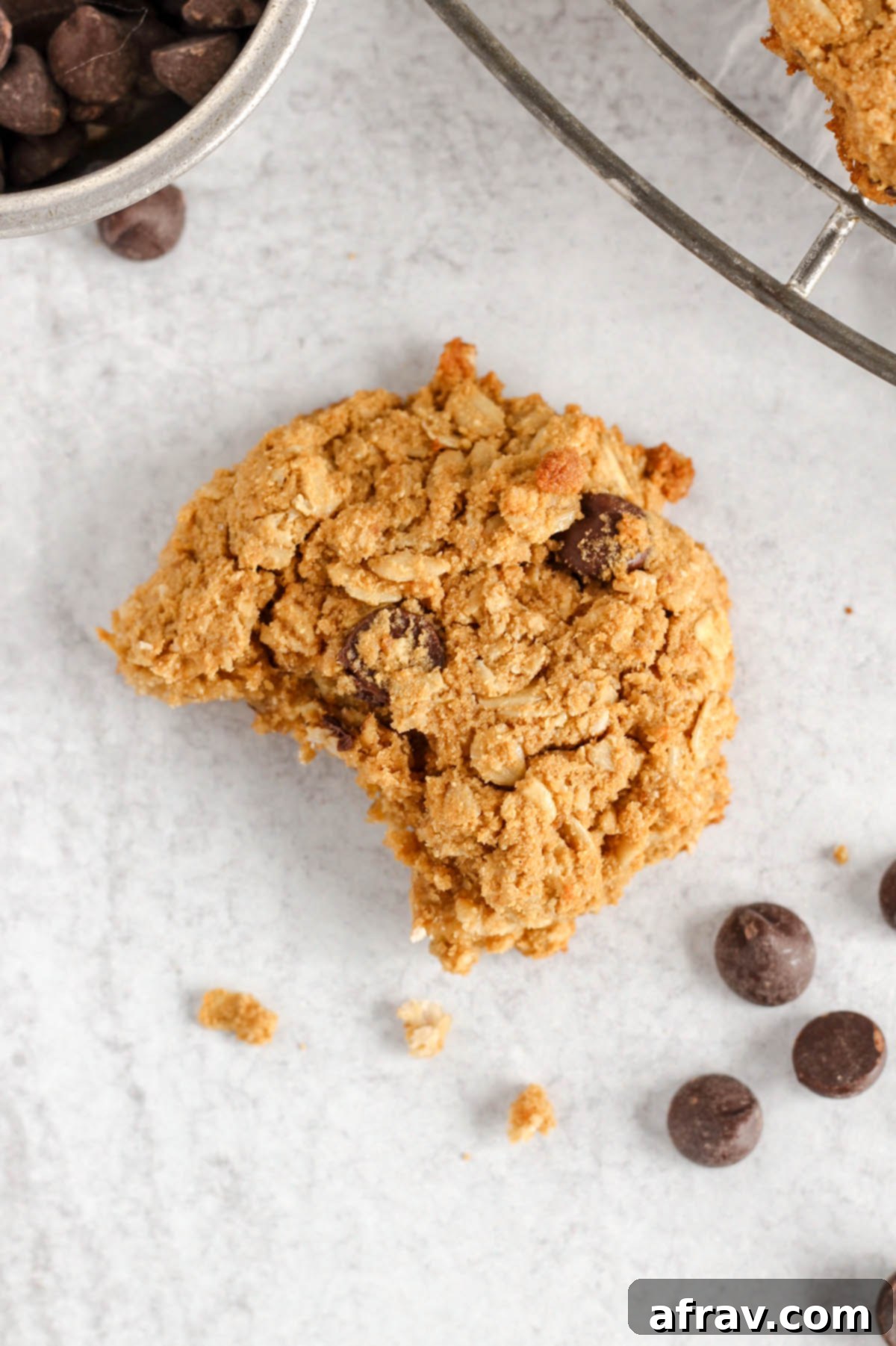 Effortless Coconut Flour Oatmeal Delights 9 Single oatmeal cookie with a bite taken out, emphasizing its soft, chewy interior.