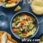 Instant Pot Lemon Chicken Orzo Soup with Fresh Kale 2 Instant Pot Chicken Orzo Soup served up in blue bowls and garnished with lemon slices.