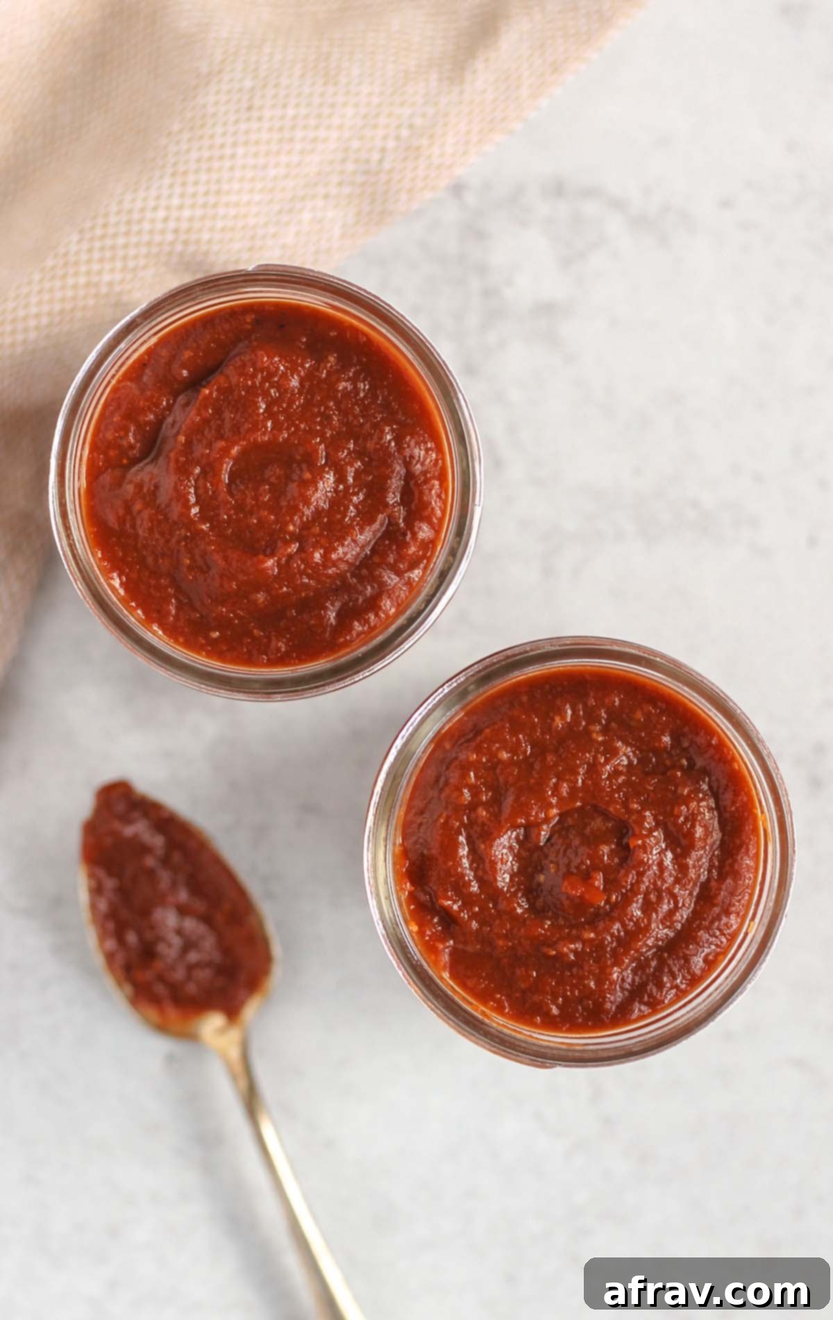 Delicious Whole30 Paleo BBQ Sauce 2 Two mason jars filled with homemade Whole30 BBQ sauce, overhead view.