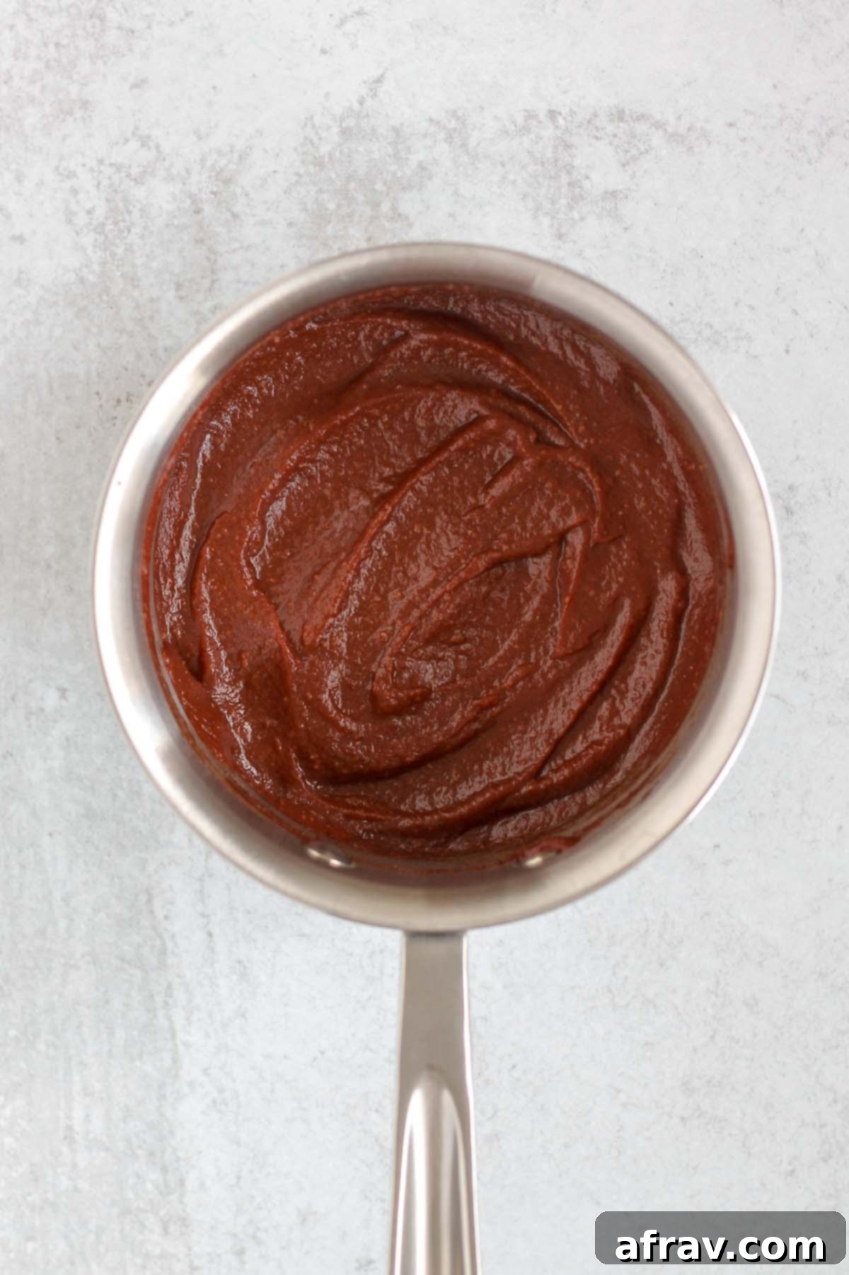 Delicious Whole30 Paleo BBQ Sauce 5 Homemade Whole30 BBQ sauce simmering in a saucepan.