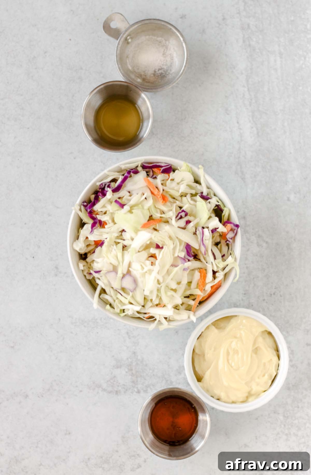 Ingredients needed for Whole30 and Paleo coleslaw, including cabbage mix, mayonnaise, apple cider vinegar, honey, and salt.