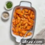 Thumbnail of perfectly roasted garlic herb air fryer carrots, presented in a white serving dish with a garnish of fresh parsley.