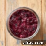 Overhead view of triple berry chia seed jam in a glass jar.