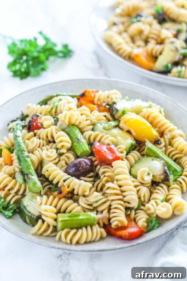 close-up view of grilled vegetable pasta salad on round plate