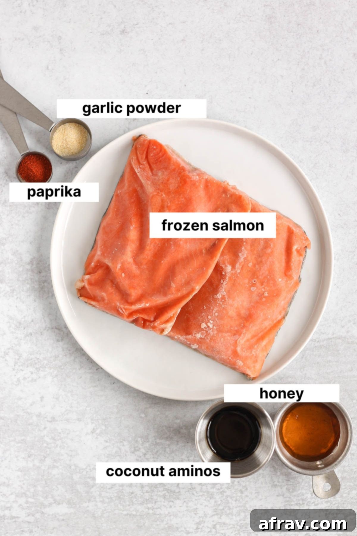 Labeled ingredients needed for frozen salmon in the air fryer.