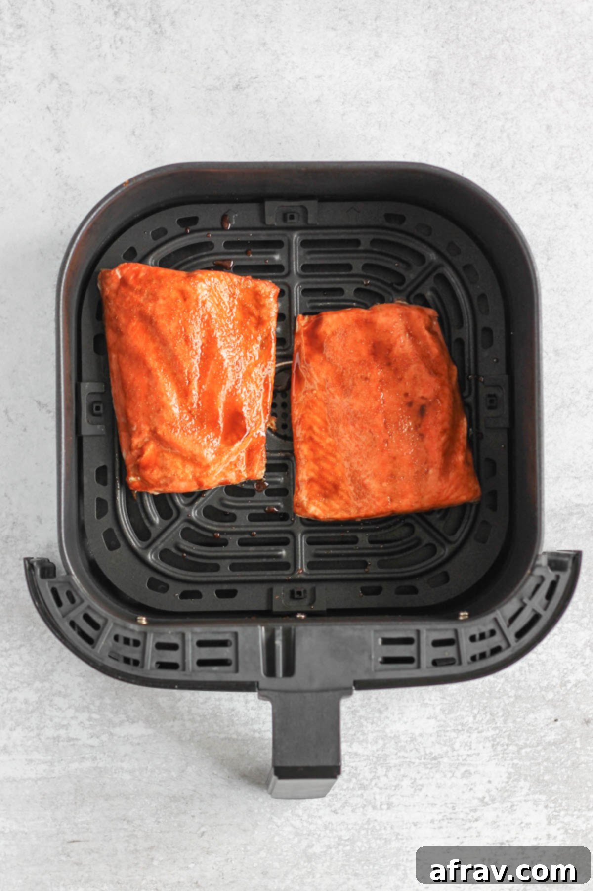 Salmon fillets in air fryer with glaze.