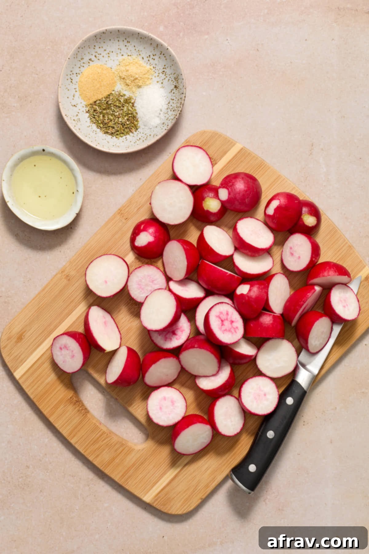 Prepped radishes on a wooden cutting board.