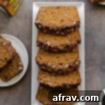 Thick slices of walnut banana bread with molasses arranged on a white plate, showcasing the streusel and moist texture.