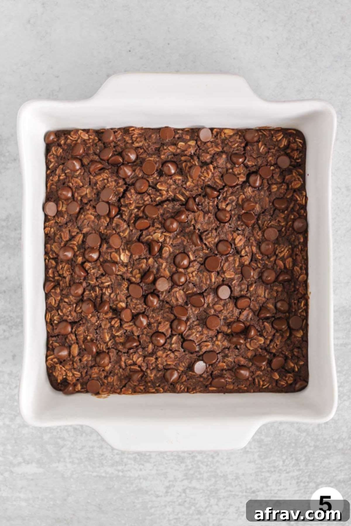 Chocolate baked oats in a square baking dish.