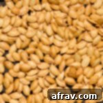 Close up view of air fryer pumpkin seeds in an air fryer basket, perfectly roasted.