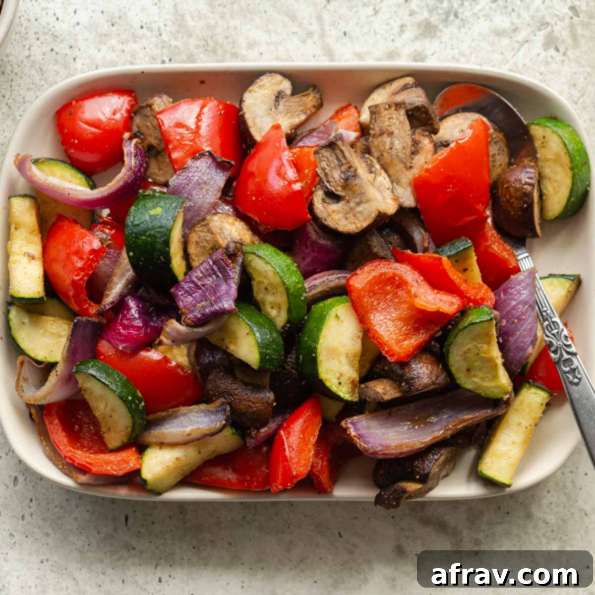 Effortless Air Fryer Side Dishes 17 Overhead view of air fryer vegetables on a rectangular plate, showcasing a healthy and colorful mix.