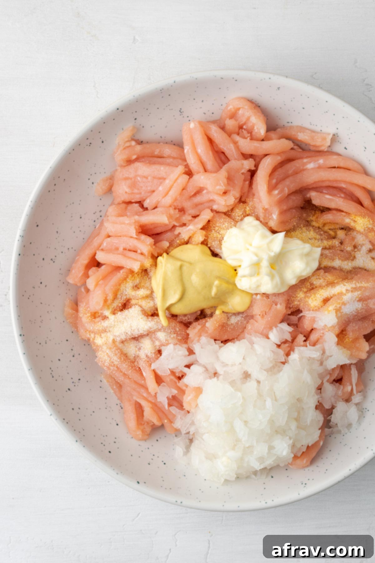 Perfectly Juicy Air Fryer Turkey Burgers 4 Ingredients for turkey burger patties in a mixing bowl.