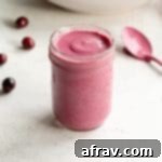 Cranberry salad dressing in a glass mason jar.