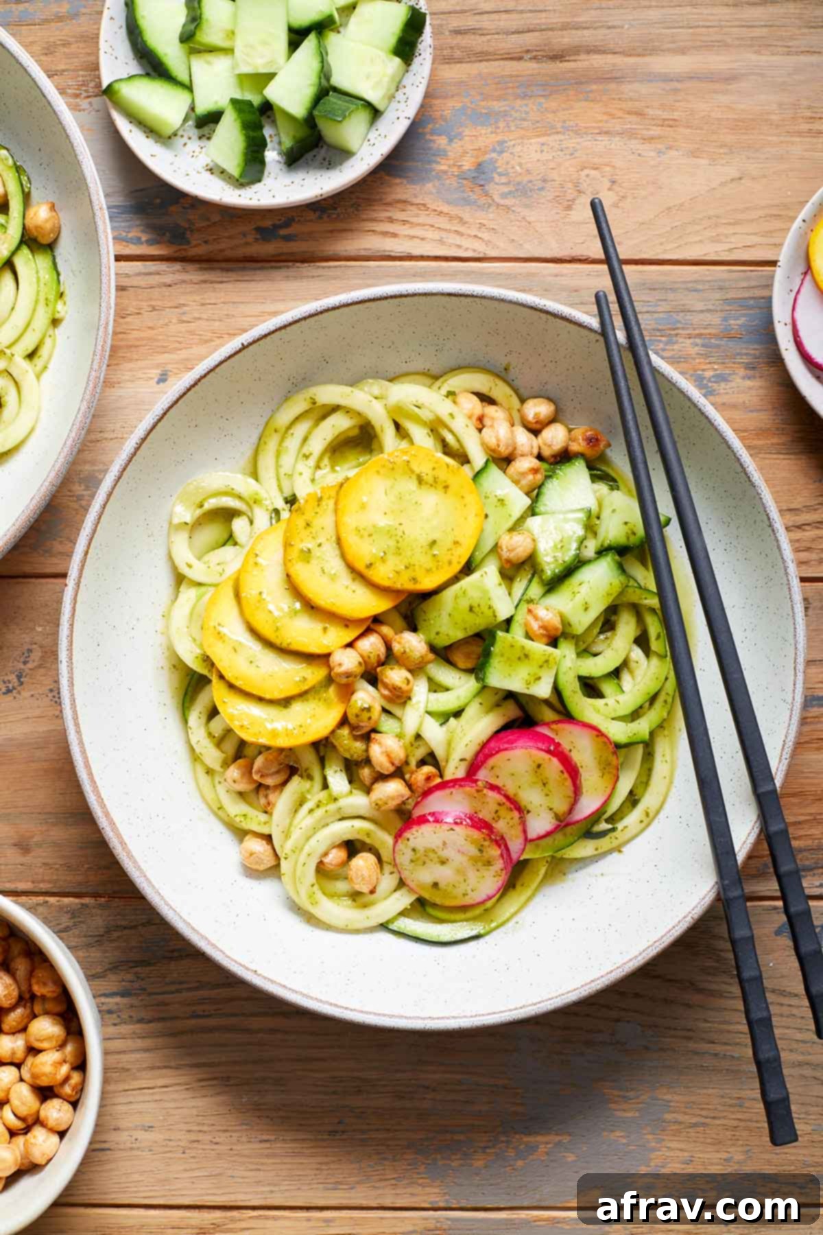 Zoodle Bowls 2 Overhead view of a zucchini noodle bowl with toppings.