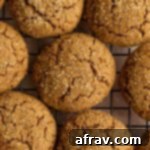 Chewy Ginger Molasses Delights Gluten Free Dairy Free 2 Ginger molasses cookies arranged on a cooling rack.