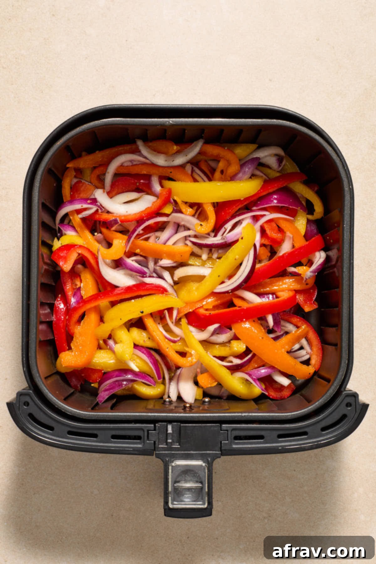 Golden Air-Fried Peppers and Onions 6 Seasoned peppers and onions added to the air fryer basket.