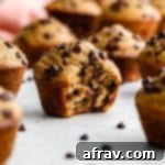 Guilt Free Spelt Banana Muffins 2 Side view of a banana spelt flour muffin with a bite taken out of it.